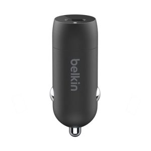 Belkin car charger in a vehicle's cigarette lighter socket, viewed from above, dark cylindrical device with a USB port on top and metal side contacts