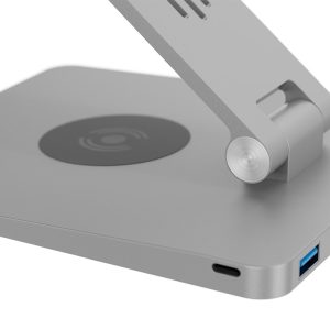 Close-up of a silver adjustable phone stand with a circular wireless charging pad on the base and a USB-C port on the side.