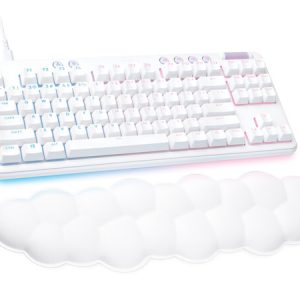 White keyboard with subtle blue/pink backlighting and a soft white cloud-shaped wrist rest beneath it.